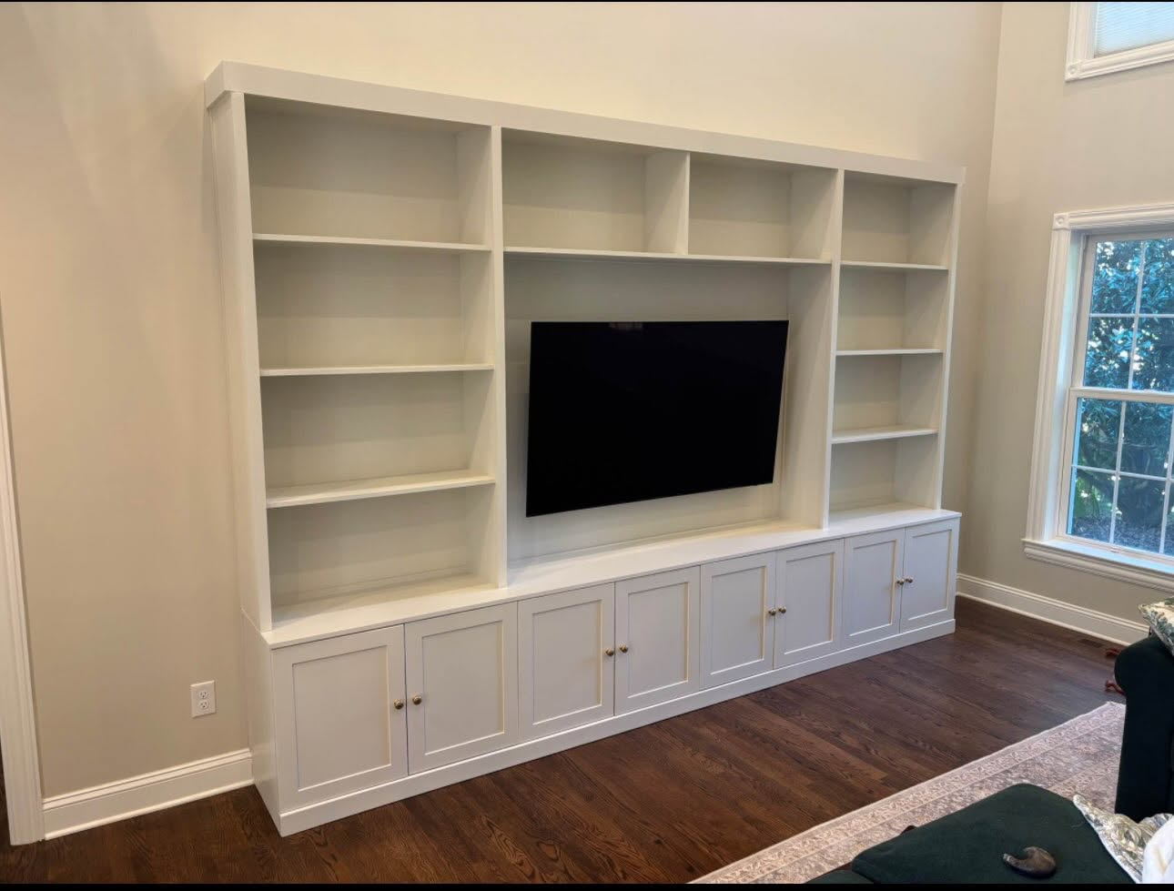 Built-in entertainment center with open shelving and closed base cabinetry in a New Jersey living room