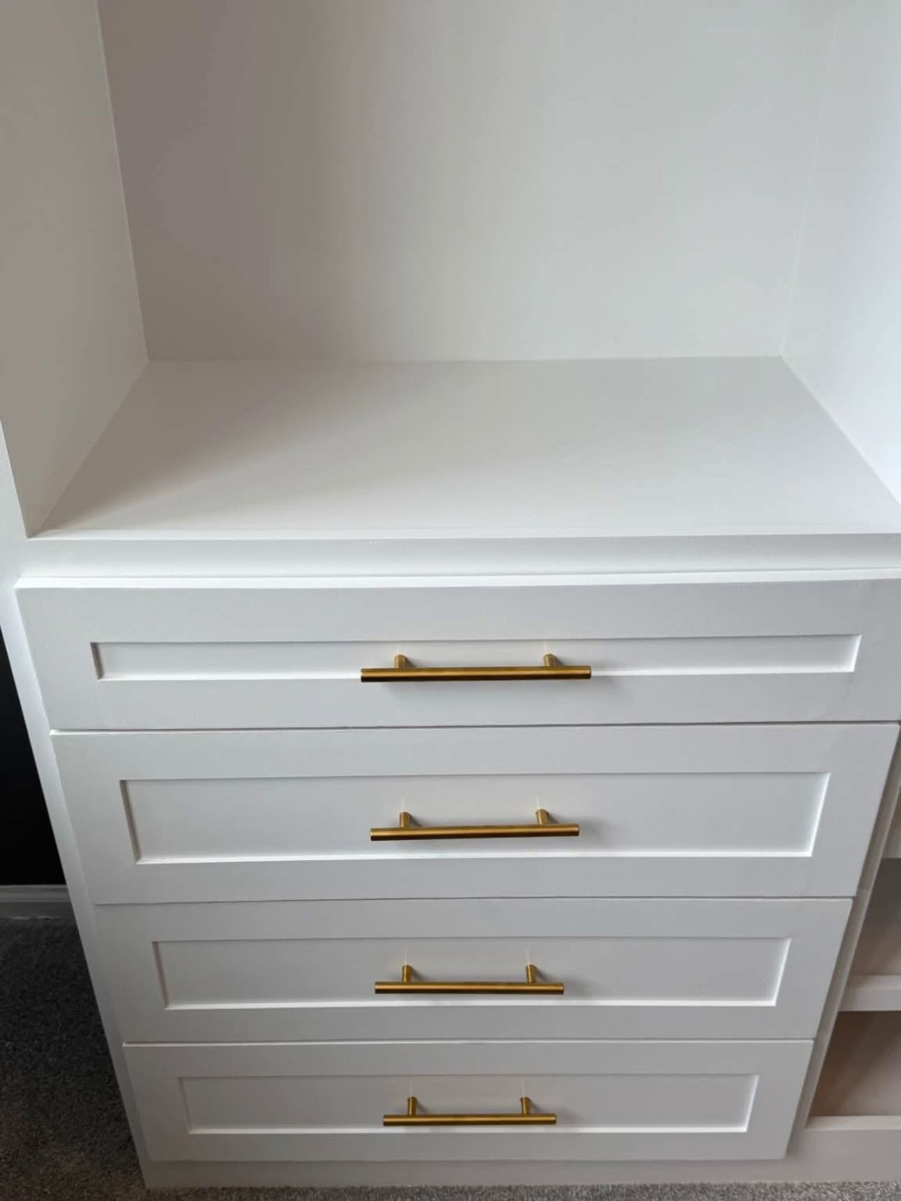Closet drawer bank with brass pulls and soft-close runners