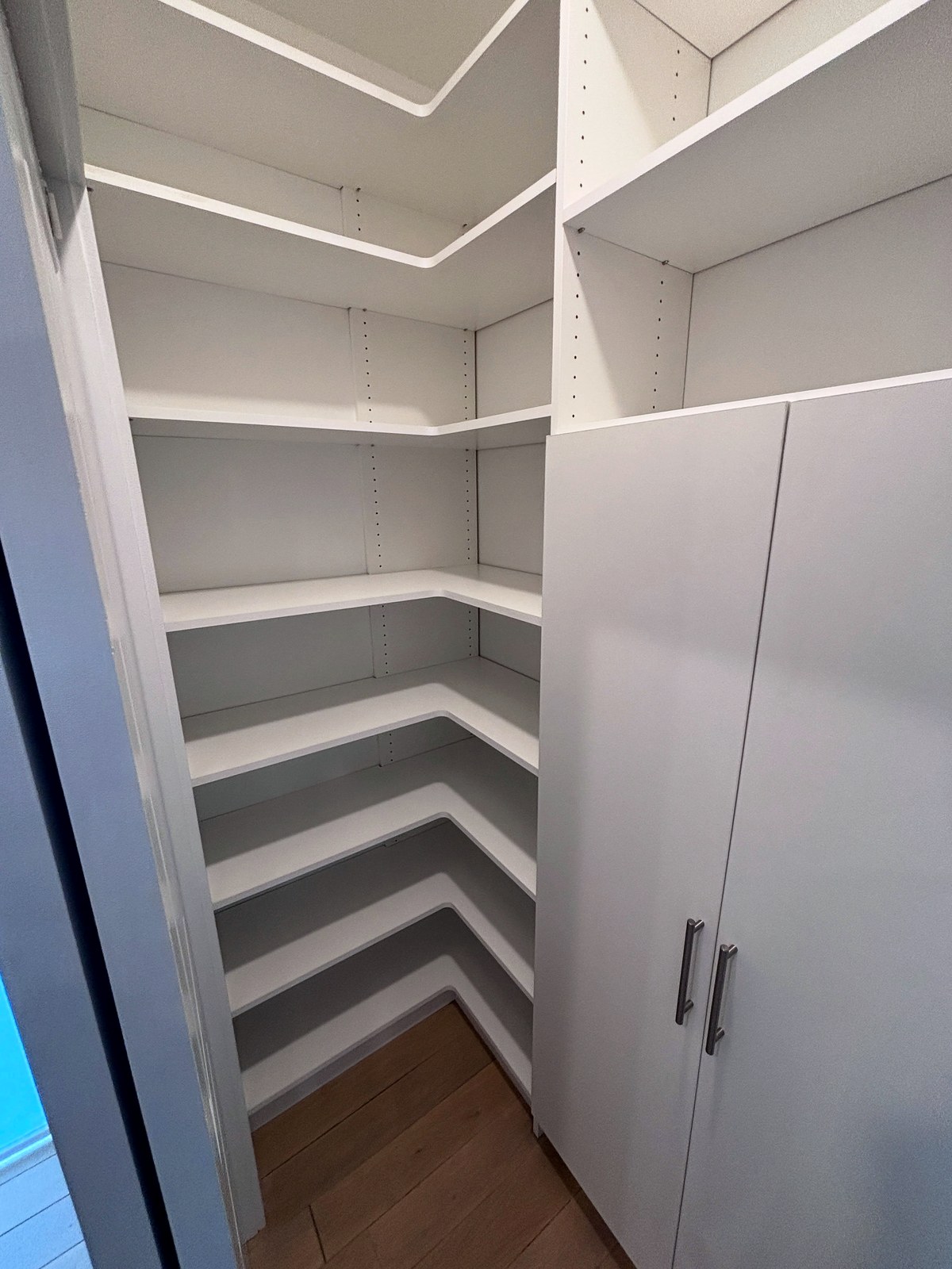 Detail of custom built-in shelving with adjustable shelves in a white finish, built by First Choice Closets in New Jersey