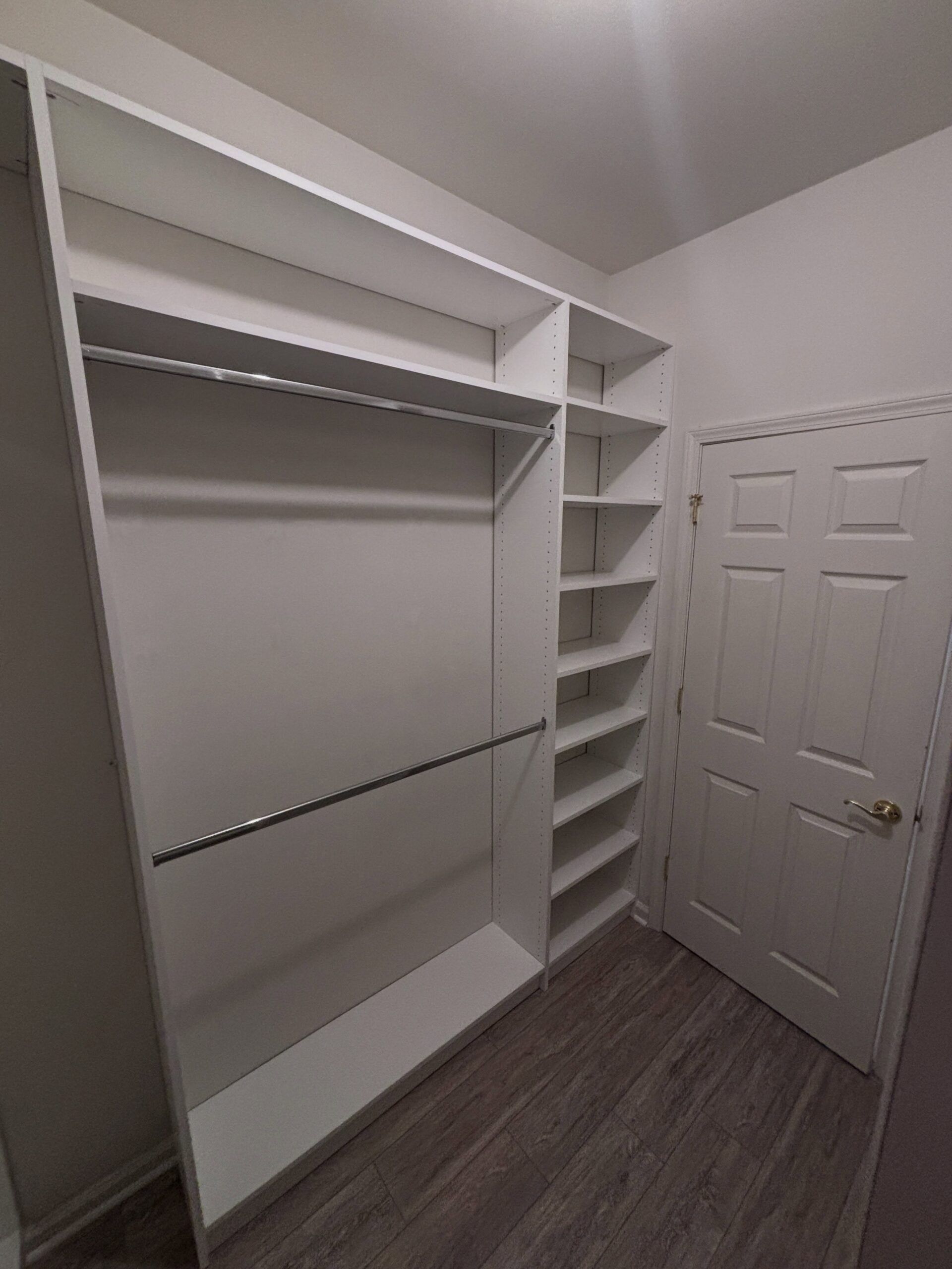 Reach-in closet with double hanging rods and adjustable shoe shelving
