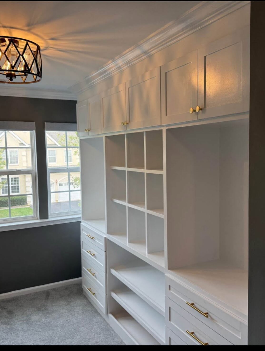 Walk-in closet with a full built-in storage wall in a Wall Township NJ home